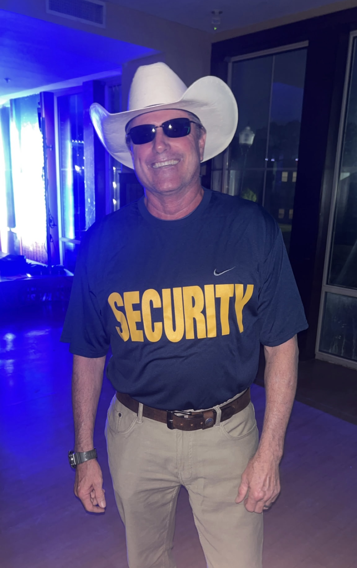 High Pi Bob Gerzel wearing a white cowboy hat, sunglasses, and a navy Security t-shirt